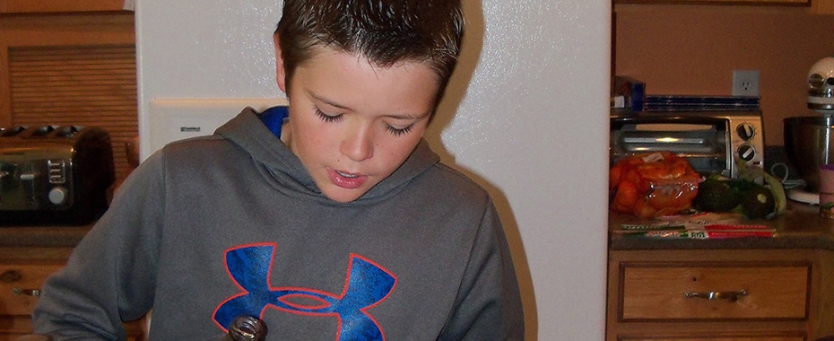 Photo of a Boy Working on a Baking Project
