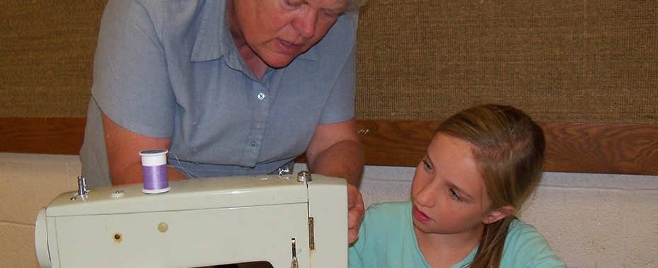 Young Lady Receiving Help on a Sewing Project